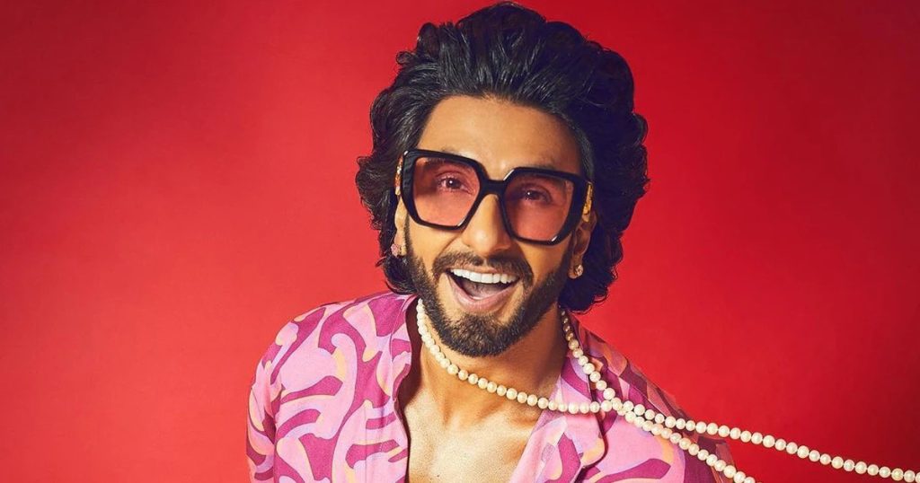 Ranveer Singh wearing oversized geometric sunglasses with a colourful outfit.